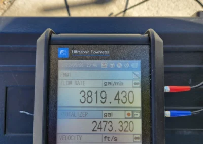 Ultrasonic flowmeter display showing real-time flowrate of 3,800 gallons per minute