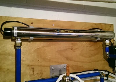 Bacteria Shield UV Light system mounted on a wall for ultraviolet water disinfection in an industrial or commercial setting