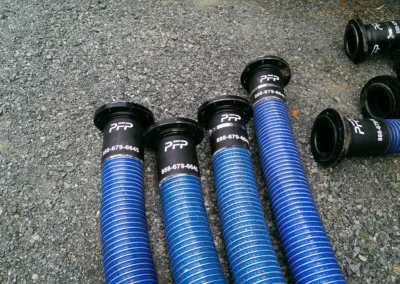 Cargo hoses with PFP-end connections staged for shipping with industrial filtration rental equipment