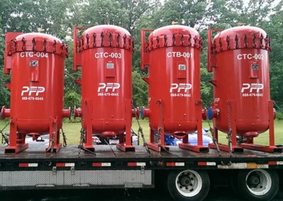 Clay treater vessel rentals secured on a flatbed truck, ready for shipment from the PFP facility to a customer site