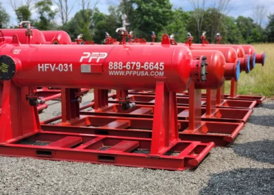Row of high flow horizontal filter vessels stored at Precision Filtration Products facility, ready for rental deployment