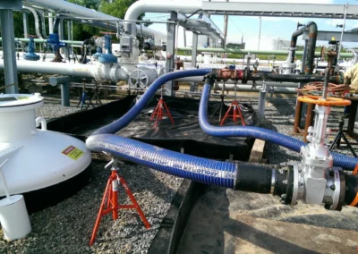 PFP hoses and gate valves connected to rental filtration equipment at an active job site