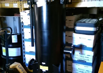 Multi-round hydraulic cartridge housings staged at Precision Filtration Products storage facility, available for rental