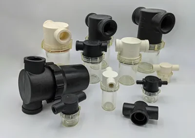 In-line vacuum filter housing for direct filtration in vacuum processing systems