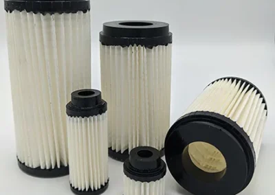 In-line pleated paper vacuum filter for fine particulate removal in vacuum systems
