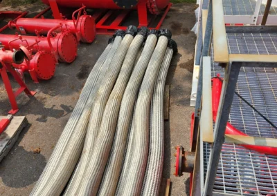 Fuel transfer hoses staged at Precision Filtration Products storage facility, ready for deployment with rental filtration systems